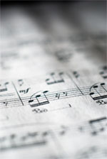 Close-up of sheet music rendered in black and white. [Short depth of field.]